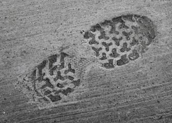 footprint of shoe or boot on concrete