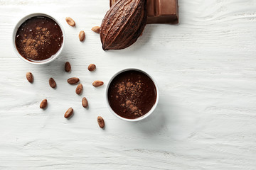Flat lay composition with delicious chocolate on wooden background