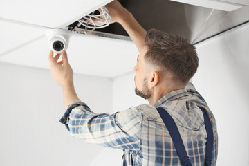 Electrician installing surveillance camera