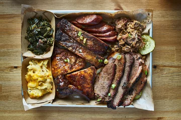 Gordijnen texas bbq style tray with smoked beef brisket, st louis ribs, chicken and hot links © Joshua Resnick