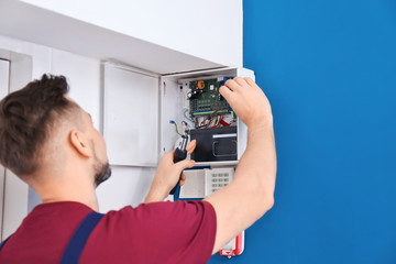 Electrician installing alarm system