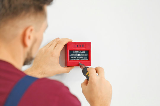 Electrician installing fire alarm system