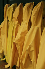 yellow windbreaker rain proof jackets hung up