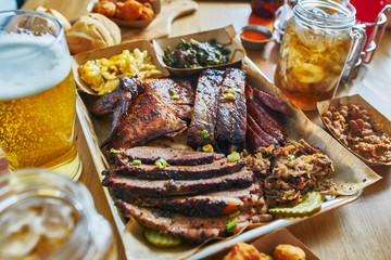 texas style bbq tray with smoked brisket, st louis ribs, pulled pork, chicken, hot links, and sides - obrazy, fototapety, plakaty