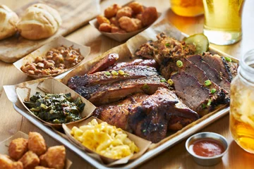  texas style bbq tray with smoked brisket, st louis ribs, pulled pork, chicken, hot links, and sides © Joshua Resnick