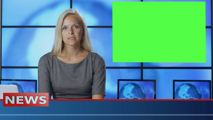 Female News Presenter in Broadcasting Studio With Green Screen Display for Mockup usage.