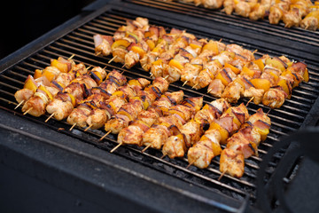 Shish kebab from chicken, pepper and bacon. Grilled vegetable and meat skewers on a grill pan.