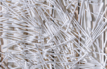 White cotton swabs scattered on the table. Background. Hygiene. Clean. Care.