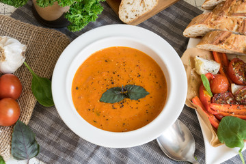Roasted pepper soup and roasted tomatoes with fresh basil and home-made onion baguette