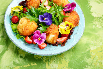 Salad leaves with strawberries,herbs and flowers