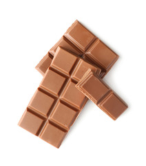 Pieces of milk chocolate on white background