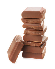 Pieces of milk chocolate on white background