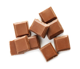 Pieces of milk chocolate on white background