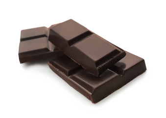 Pieces of dark chocolate on white background