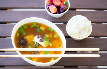 Traditional vegan miso soup with silken tofu, shiitake, dashi and scallion served with white rice and pickled vegetables