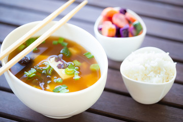 Traditional vegan miso soup with silken tofu, shiitake, dashi and scallion served with white rice and pickled vegetables