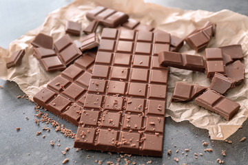 Tasty milk chocolate on table