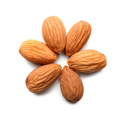Flower made of tasty almond nuts on white background