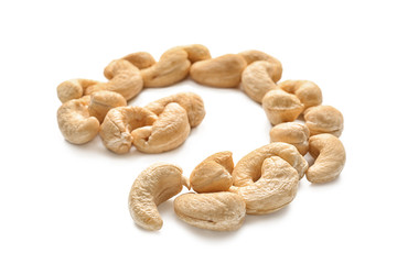 Spiral made of tasty cashew nuts on white background