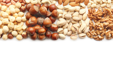 Different types of nuts on white background