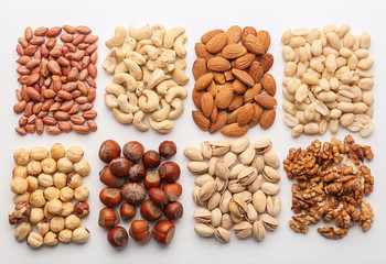 Composition with different types of nuts on white background