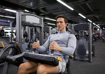 Young man training in modern gym