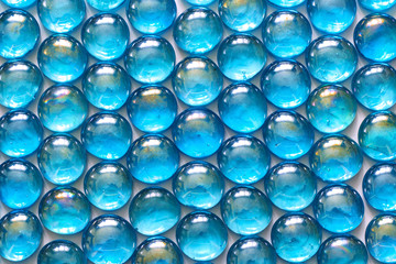 Background of shiny turquoise glass stones.