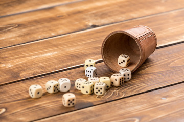 cup dice on wooden background