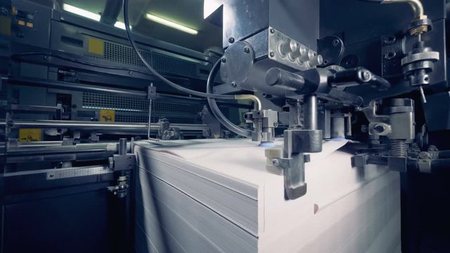 Modern equipment works with paper at a print factory. Paper production process.