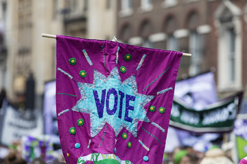A vote banner raised in the air at a political protest march
