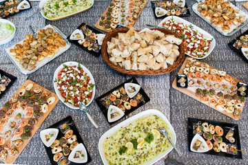 catering - table with different type of snacks preparing for party.