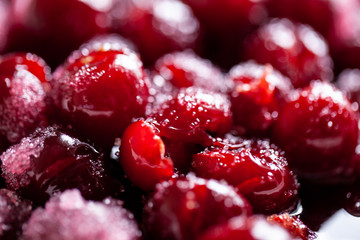 Cherry jam. Close up of simmering homemade cherry jam. Cherry and sugar crystal. Stewed cornel (dogwood or cornelian cherry) background or texture. Rfood background. Macro close-up. food photography