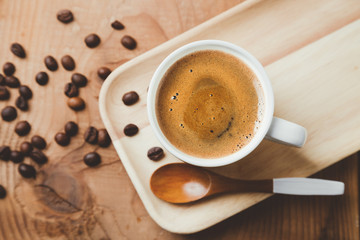 Top view of a espresso coffee cup with a wooden spoon