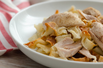 Homemade noodles are cooked with chicken and chicken broth