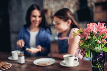 mother spreading toast with with chocolate paste