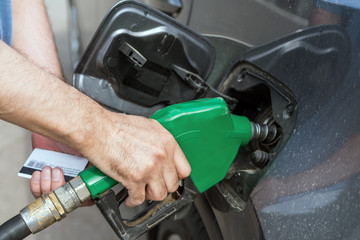 Fototapeta premium Hand refilling the car with fuel