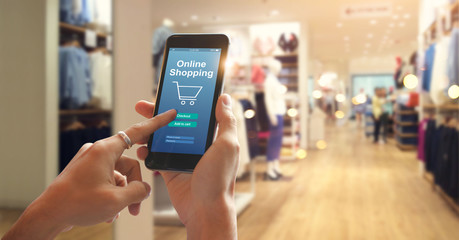 Fototapeta na wymiar Smart phone online shopping in woman's hand. Network connection on mobile screen. Payments online. Shopping mall department store background
