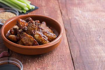 Traditional Asian stir fry chicken wings with sesame and vegetables