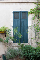 Fototapeta na wymiar Blue window shutter and lavender in Saint-Remy-de-Provence, France
