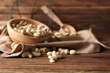 Fototapeta na wymiar Tasty cashew nuts on wooden background