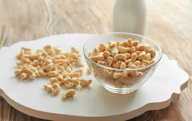 Bowl with tasty cashew nuts on table