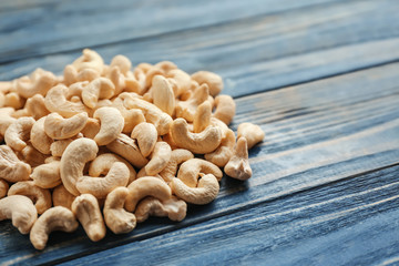 Tasty cashew nuts on wooden background