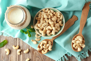 Composition with tasty cashew nuts on wooden background