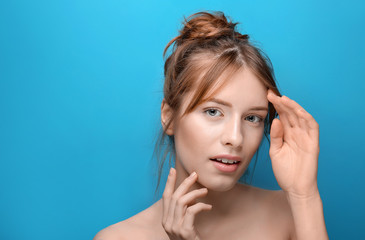 Fototapeta premium Beautiful young woman with silky skin on color background