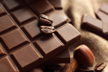 Tasty chocolate and coffee beans, closeup