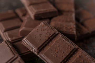 Tasty milk chocolate and cocoa powder, closeup