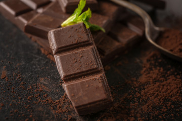 Tasty milk chocolate and cocoa powder, closeup