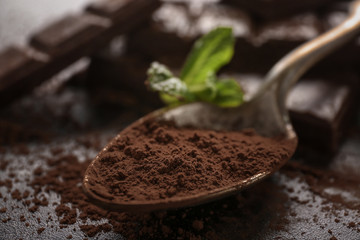 Spoon with tasty cocoa, closeup. Ingredient for chocolate