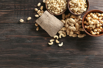 Composition with different nuts on wooden background