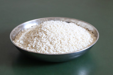 metal bowl full of raw rice